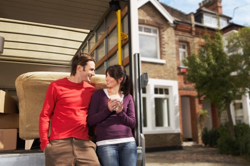 Professional movers handling boxes and furniture for a small removal